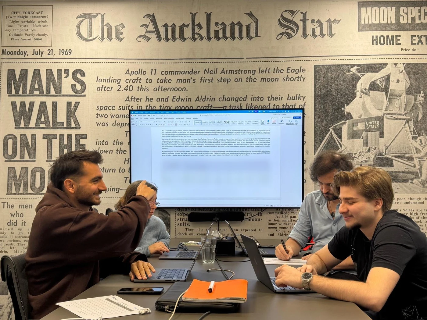 Partner representatives at work around a shared table during the ENTREMIND kick-off meeting in Warsaw.